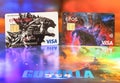 Close-up of Japanese Visa cards illustrated with Godzilla monster.