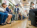 Tokyo, Japan - Jan 2, 2016. People sitting in a Yamanote train in Tokyo, Japan. The railway system in Japan has a high Royalty Free Stock Photo