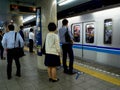 Tokyo, Japan - Jan 2, 2016: Unidentified people waiting to take the Yamanote train in Tokyo, Japan. The railway system Royalty Free Stock Photo