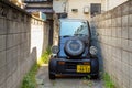 Tokyo, Japan - November 3, 2020 : Daihatsu Midget II Japanese small city car. mini cars parking in a narrow alley at the house in