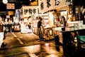 Tokyo, Japan - January 15, 2010: Early morning in Tsukiji Fish Market. Worker laying out fresh fish and seafood on the counter