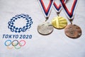 TOKYO, JAPAN, JANUARY. 20. 2020: Gold silver and bronze medal set, olympic logo Tokyo 2020 on white background