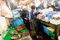 Tokyo, Japan - January 15, 2010: Vendor cutting fish at Tsukiji Fish Market. Early morning at the fish market