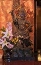 Wooden statue depicting one of the Four Heavenly Kings buddhist deity of Jikokuten depicted holding a sword in the Tendai Buddhism