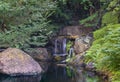 Closeup long exposure of a small waterfall in the Japanese Garden of Hotel New Otani. Royalty Free Stock Photo