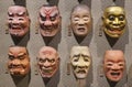 Eight Japanese Noh theater masks depicting various faces expressions.