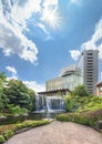 Pond of the Hotel New Otani Japanese Garden overlooked by a big waterfall. Royalty Free Stock Photo