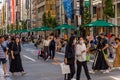 TOKYO, JAPAN - JULY 30 2023: Shoppers on the closed roads of Ginza, the luxury retail district of central Tokyo