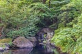 Small waterfall in the pond of the Japanese Garden of Hotel New Otani. Royalty Free Stock Photo