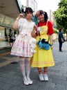 Two Japanese girls pose on Takeshita Street in the Harajuku district. This street is famous for anime