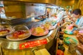 TOKYO, JAPAN -28 JUN 2017: Unidentified people eating an assorted japanesse food over a table, inside of a kaitenzushi