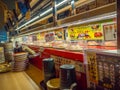 TOKYO, JAPAN -28 JUN 2017: View of assorted japanesse food over a table, inside of a kaitenzushi conveyor belt sushi