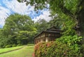 Azalea shrub along Japanese Kakuuntei teahouse in Meiji Jingu Inner Garden.