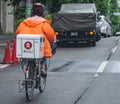 Delivery Cyclist In Tokyo Street, Japan