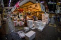 TOKYO, JAPAN JUNE 28 - 2017: Unidentified man working accommodating a pile of white boxes in Tsukiji Market is the Royalty Free Stock Photo