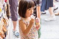 Tokyo, Japan - 13 June 2015 - Young little Asian girl enjoy her soft ice cream outside of a snack shop in Tokyo, Japan on June 13