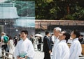 Tokyo, Japan - Kannushi men talking to each other while preparing traditional Shinto-style wedding ceremony at Meiji Shrine. Royalty Free Stock Photo