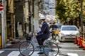 Tokyo, Japan, 04/12/2019: A man in a helmet on a bicycle on a city street