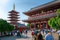 Tokyo, Japan - 05.13.2019: Many people walking in the area of Asakusa temple on a sunny day. Traditional pagoda and main temple