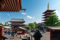 Tokyo, Japan - 05.13.2019: Many people walking in the complex of Asakusa temple on a beautiful sunny day. Traditional pagoda