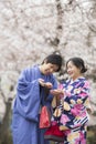 Tokyo, Japan- March 29,2019 an asian couple wearing traditional japanese clothes in blooming cherry blossom festival Royalty Free Stock Photo