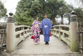 Tokyo, Japan- March 29,2019 an asian couple wearing traditional japanese clothes standing in a middle of old classic bridge Royalty Free Stock Photo