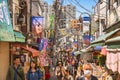 Crowd of people sightseeing the retro shopping street of Yanaka Ginza in Tokyo.