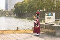 Woman in kimono reading a guide book at Tokyo Imperial palace.