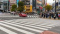 People walking along the busy streets and crossing at the famous Shibuya Crossing in Tokyo, Japan