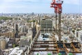 Bunkyo Garden Gate Tower under construction with elevated cranes and load-bearing beams in Tokyo.