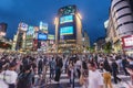 Crowds crossing Shibuya scramble crossing, the famous intersection in Tokyo outside Shibuya station