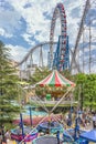 Families enjoying trampoline, carousel, roller coaster and Ferris wheel in Laqua Tokyo Dome City Mall.