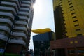 Gold flame by Philippe Starck over the Asahi Beer Headquarter between tall buildings in the sunset