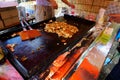 Street trading. Japanese street food. Yakisoba is prepared by frying wheat noodles