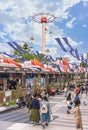 Umbrellas attraction Sky Flower overlooking Tokyo Dome City adorned by Japanese carp streamers koinobori. Royalty Free Stock Photo