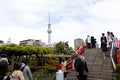Tokyo, Japan, May 1, 2019 : Unidentified tourist travel to see bloom fuji wisteria at Kameido Tenjin shrine with Tokyo skytree and