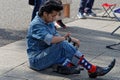 Big shoes man sitting after dance