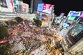 Tokyo, Japan - Nov 3, 2019: Crowded people walking, car traffic on Shibuya scramble crossing at night. Tokyo travel landmark Royalty Free Stock Photo
