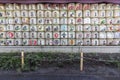 TOKYO, JAPAN - NOVEMBER 04, 2019: Consecrations of Meiji Jingu Shinto shrine, traditional sake wine barrels background, Tokyo.