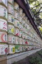 TOKYO, JAPAN - NOVEMBER 04, 2019: Consecrations of Meiji Jingu Shinto shrine, traditional sake wine barrels background, Tokyo.