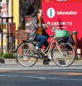 TOKYO, JAPAN - NOVEMBER 7, 2017: Elderly woman on a bicycle on a city street. Copy space for text.