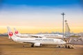 TOKYO, JAPAN - 26 NOVEMBER 2018. Japan Airlines or JAL plane at Haneda International Airport.In the Morning sun Yellow sky.Ground