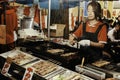 Tokyo, Japan - November 1, 2022 : Local Japanese street food at night market in Tokyo, Japan. woman grilling yakitori pork and