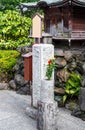 TOKYO, JAPAN - NOVEMBER 7, 2017: Stone vase with flowers and a letter box in the city park. Vertical.