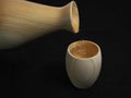 Wooden hinoki sake bottle, tokkuri, and wooden cup, Guinomi or Ochoko.