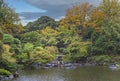 Autumn rain wetting a lantern of the pond of Japanese garden of Kyu Furukawa Park. Royalty Free Stock Photo