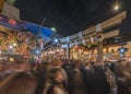 Crowd passing through the stone torii gate of Tori-no-Ichi Fair in Ootori shrine.