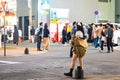 Tokyo, Japan - October 15, 2022: Cute girds cosplay on night streets of Tokyo displaying ads Royalty Free Stock Photo