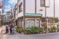 Elderly women with bicycle and sylver rollator car on the corner of a neighborhood street of Kanegafuchi. Royalty Free Stock Photo