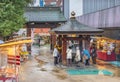 Japanese elderlies in the rain around a Buddhist censer in the Koganji temple of Sugamo.